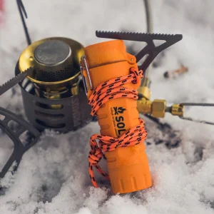 Fire Lite Fuel Free Lighter leaning on stove in snow